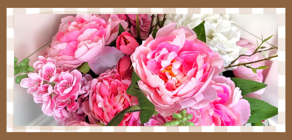 Bunch of pink peonies snapdragons tulips and a white hydrangea blossom
