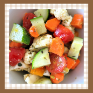 Crunchy-Veg-Salad-Recipe | The Granite Acorn Closeup of vegetable salad with chopped cucumber orange bell pepper cherry tomatoes cauliflower and carrots