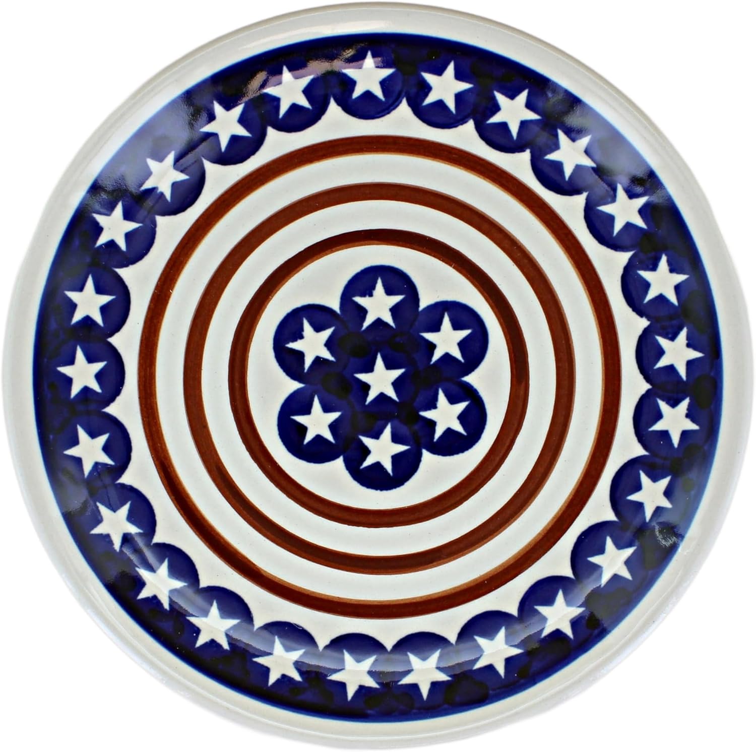 Plate | The Granite Acorn White dinner plate with a blue border with white stars three concentric red circles and a dark blue floral shaped design in the center with white stars