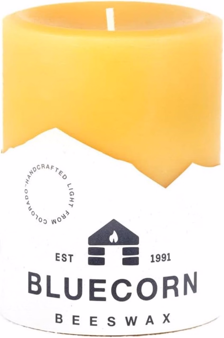 Beeswax-Candle | The Granite Acorn Unlit amber beeswax candle with a white label reading 'bluecorn beeswax' and a small house logo 'est 1991' on the label