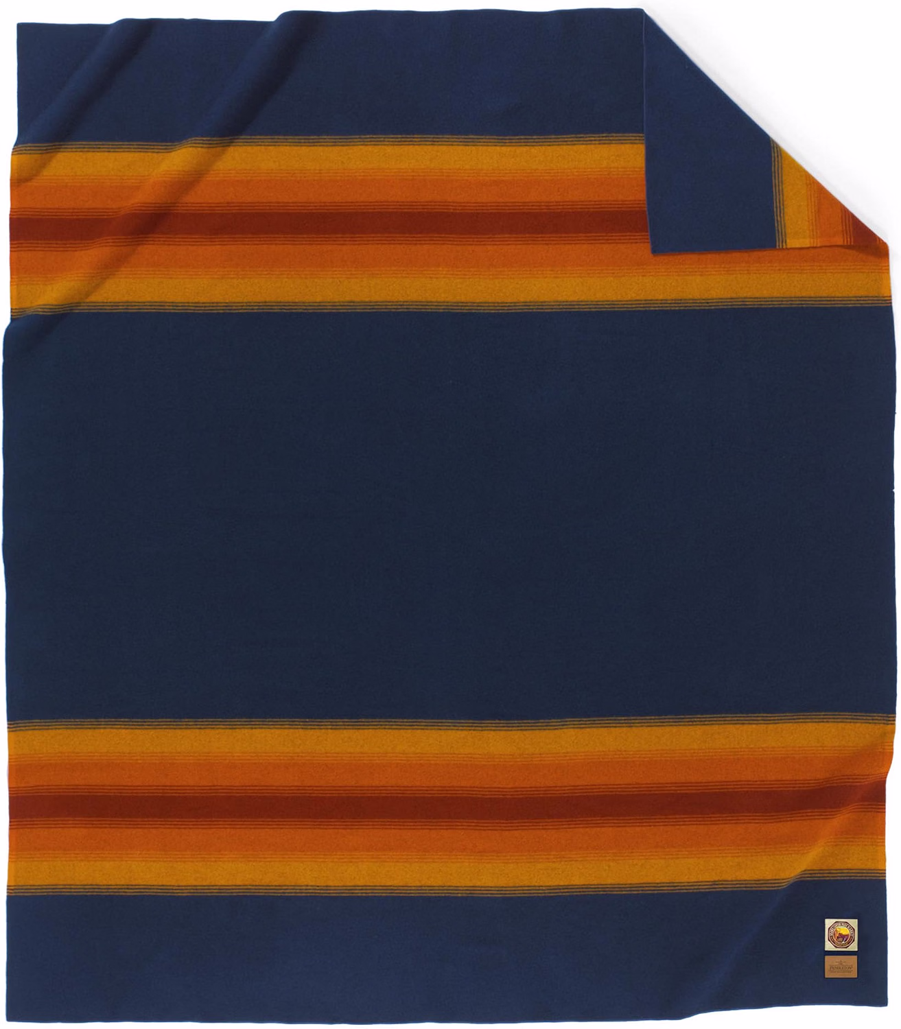Pendleton-Blanket | The Granite Acorn Navy blue blanket with broad orange yellow stripes running horizontally across the middle and bottom laid flat with a folded corner at the top right